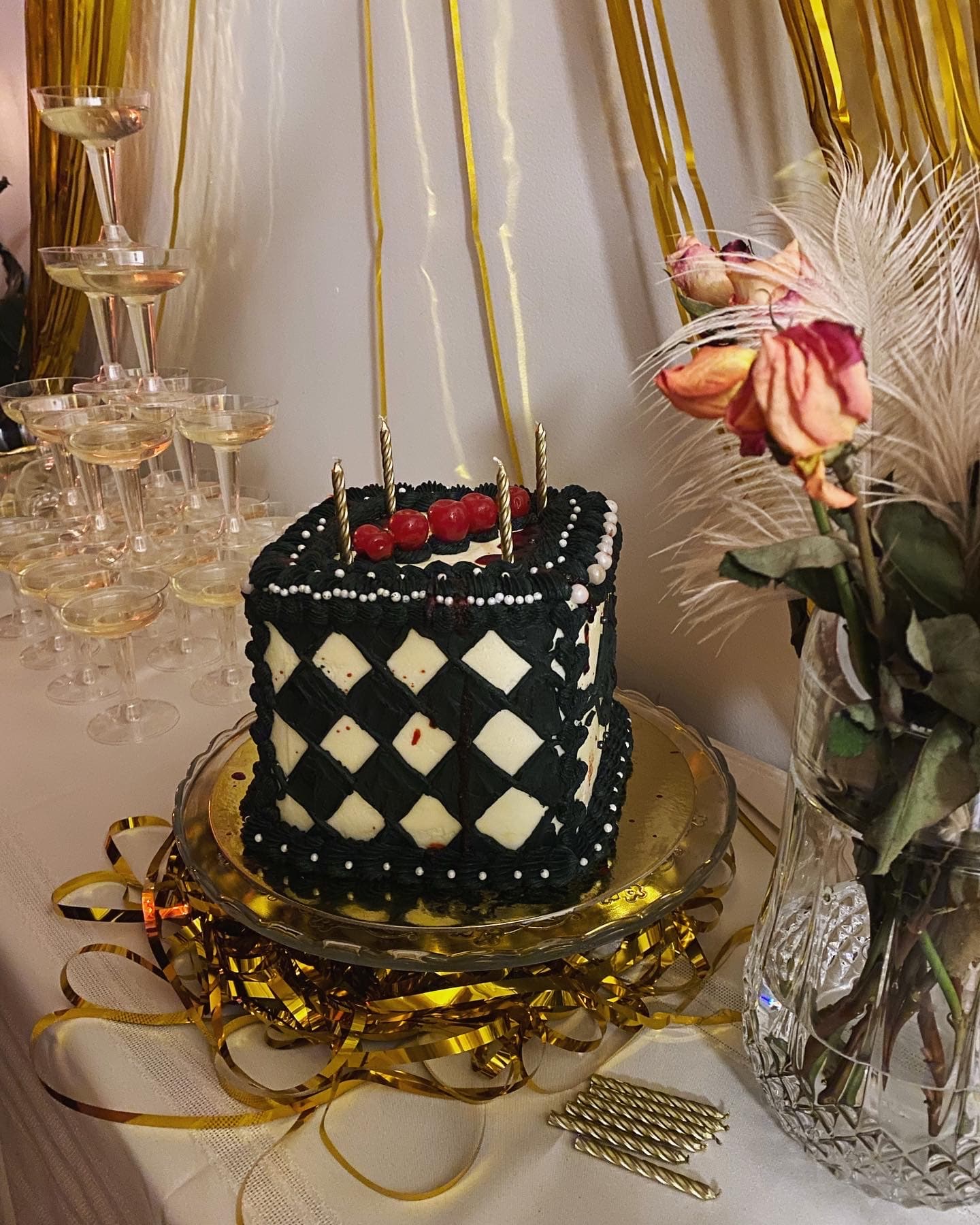 photo of a sqaure cake with black and white diamond checkered pattern