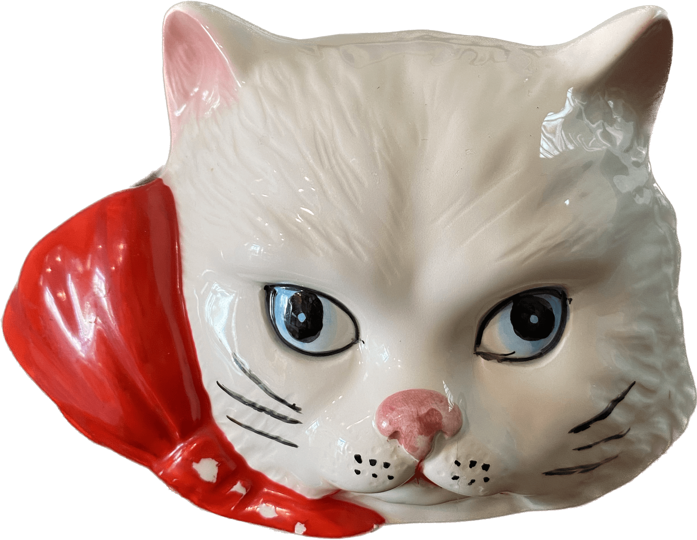 Picture of a ceramic cat head with bow around the neck